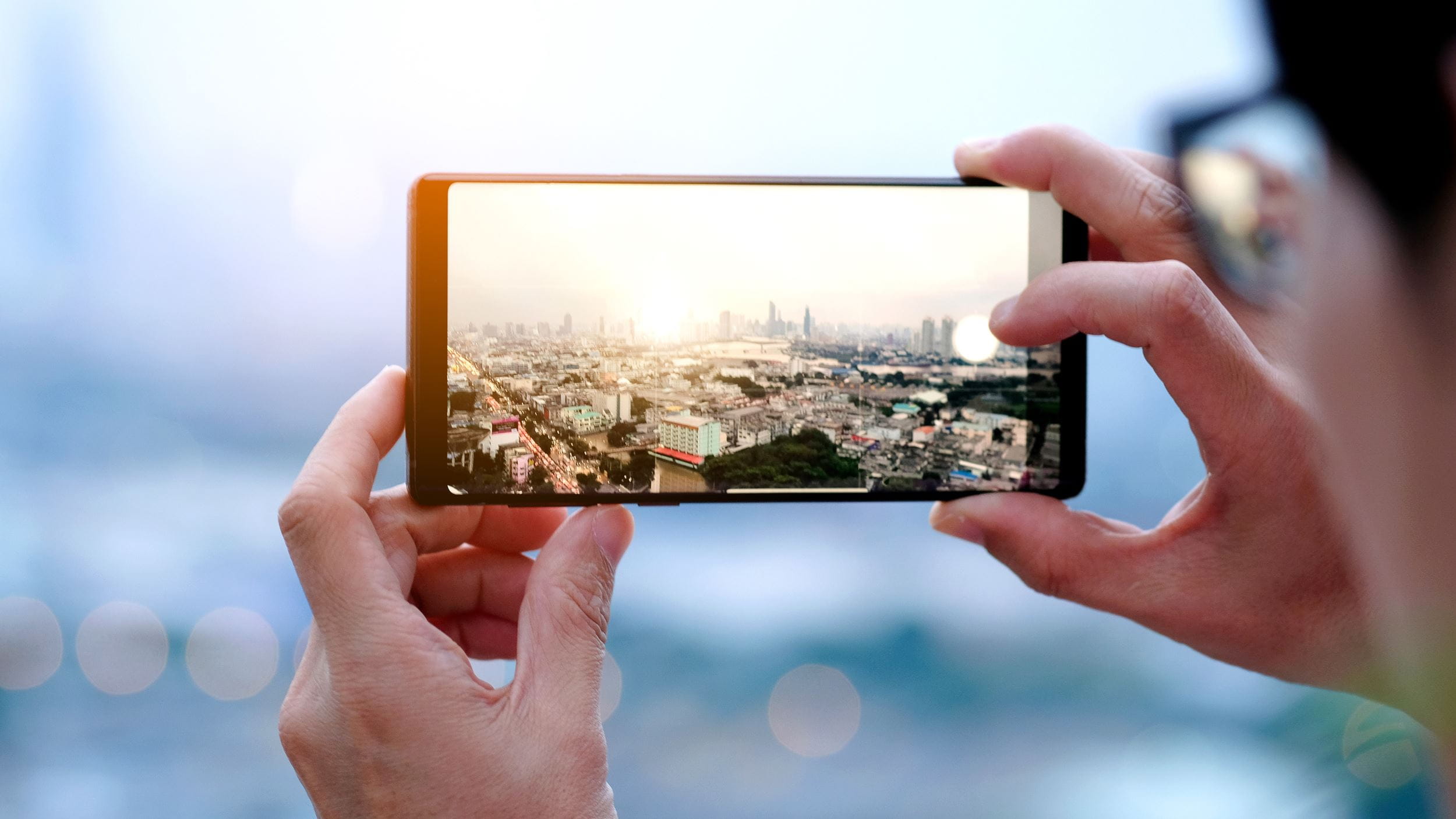 People photograph the city's buildings with a cell phone camera