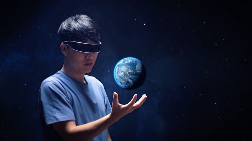 Man with virtual realtiy glasses holding the earth