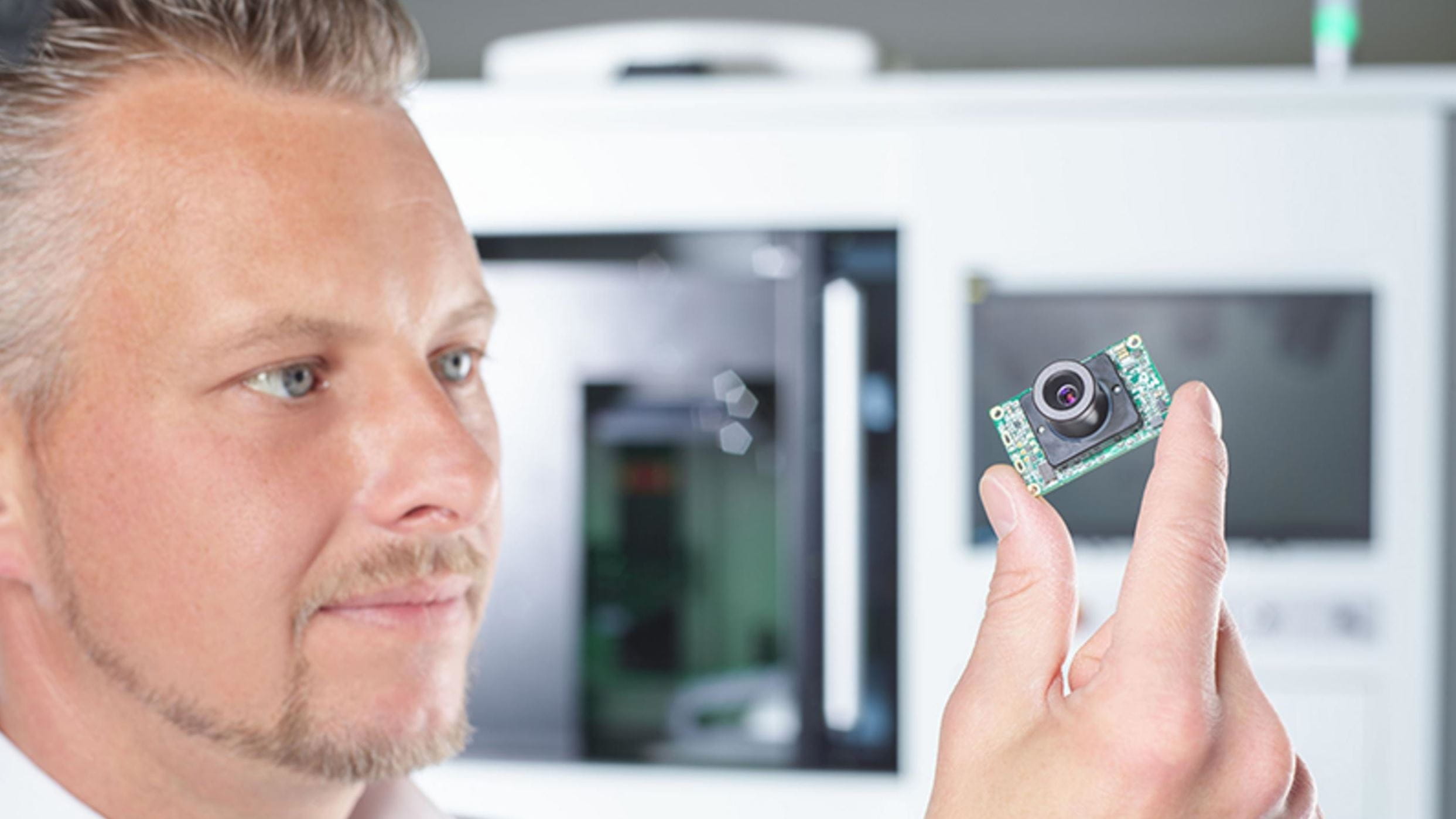 Man holding up a camera module